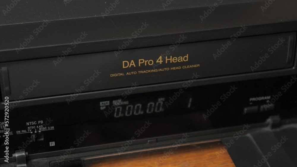 Loading a VHS tape into a video player. Video imaging technologies. Loading a VHS tape into a video player. Video imaging technologies.