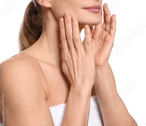 Woman massaging her face on white background, closeup