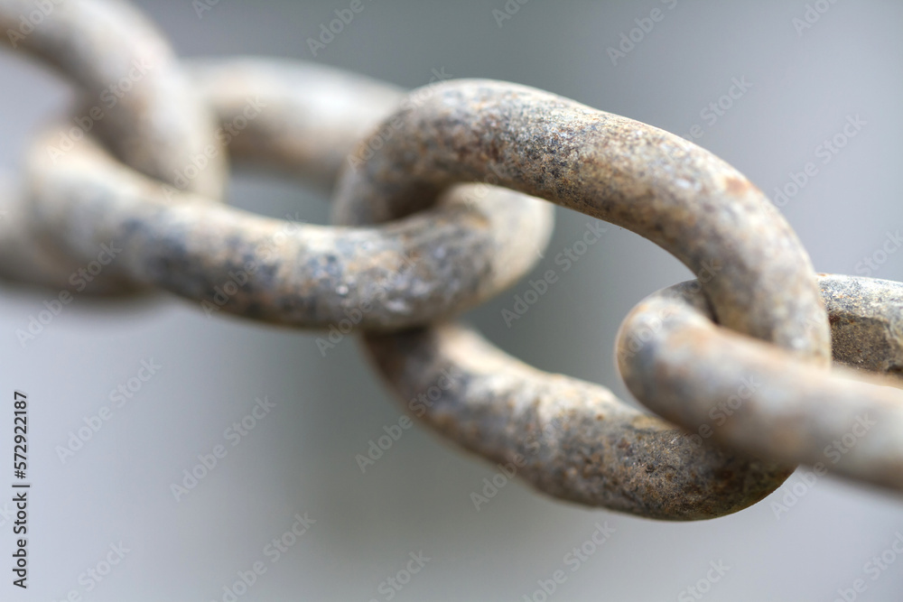 Close up view of rusty metal chain links on a gray background Close up view of rusty metal chain links on a gray background