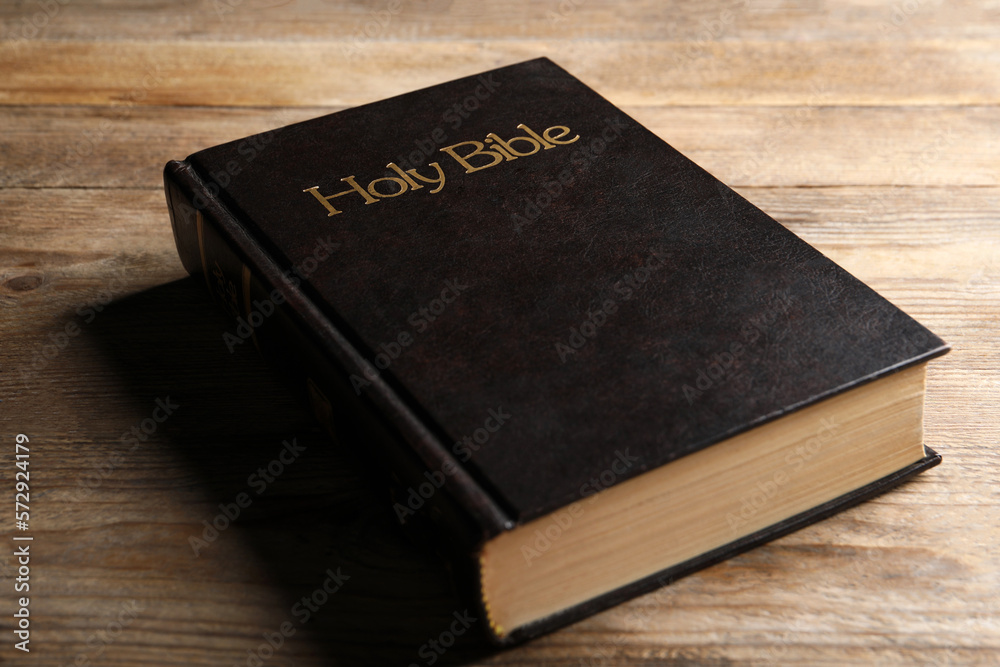 Bible with dark cover on wooden table. Christian religious book Bible with dark cover on wooden table. Christian religious book