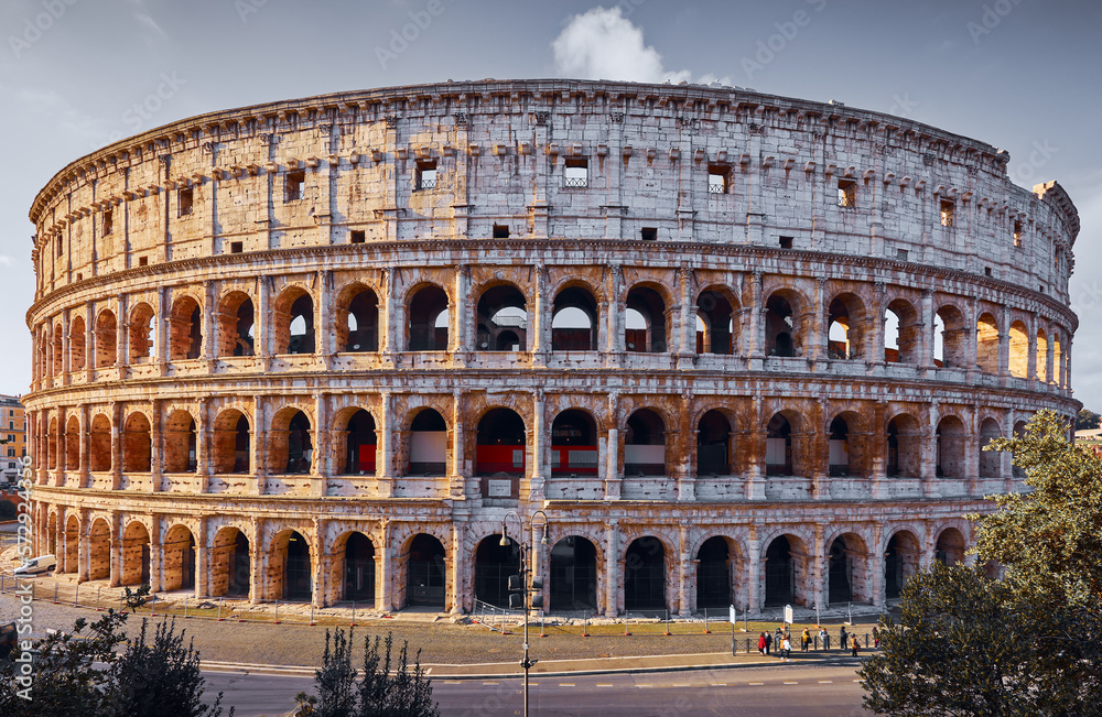 Rome, Italy. Roman Colosseum (Coliseum or Colosseo) ancient ruins of Flavian Amphitheatre. Arena for gladiator fightings. World famous landmark and very popular touristic destination vacation trip