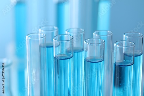 Test tubes with light blue liquid in laboratory, closeup