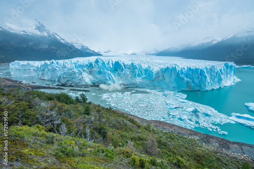 View of the beautiful Perito Moreno Glacier and a huge block of ice dropping from the glacier - El Calafate, Argentina