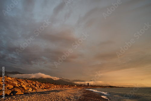 Sunset on the Black Sea coast with mountains in the background © Koscya