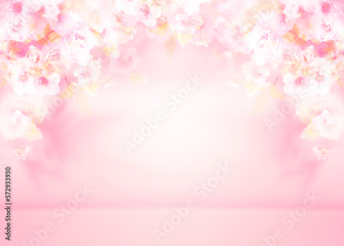 Spring summer blurred light pink background with shadow of the tree leaves and flowers on a wall. Abstract Spring Summer scene for product presentation.
