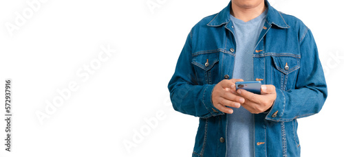 Asian man in shirt and jeans holding mobile phone