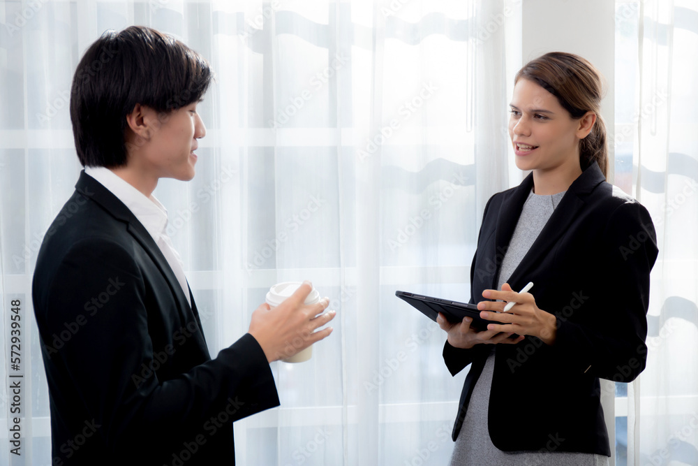 Young manager talking with secretary about report marketing on digital tablet for planning at office, executive discussion with employee woman together, leadership and employee, business concept. Young manager talking with secretary about report marketing on digital tablet for planning at office, executive discussion with employee woman together, leadership and employee, business concept.