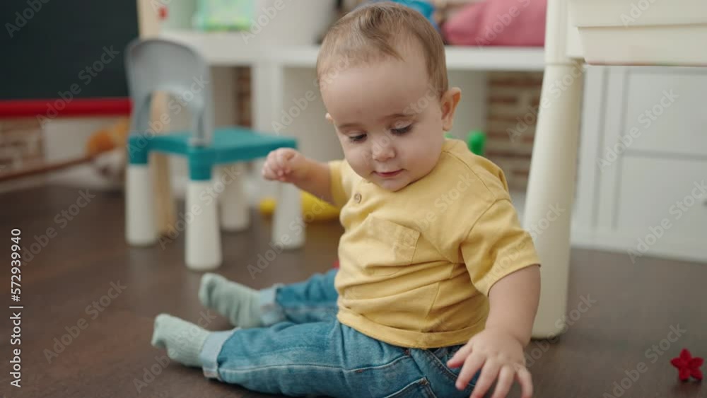 Adorable hispanic baby smiling confident relaxed on mother hands at kindergarten Adorable hispanic baby smiling confident relaxed on mother hands at kindergarten
