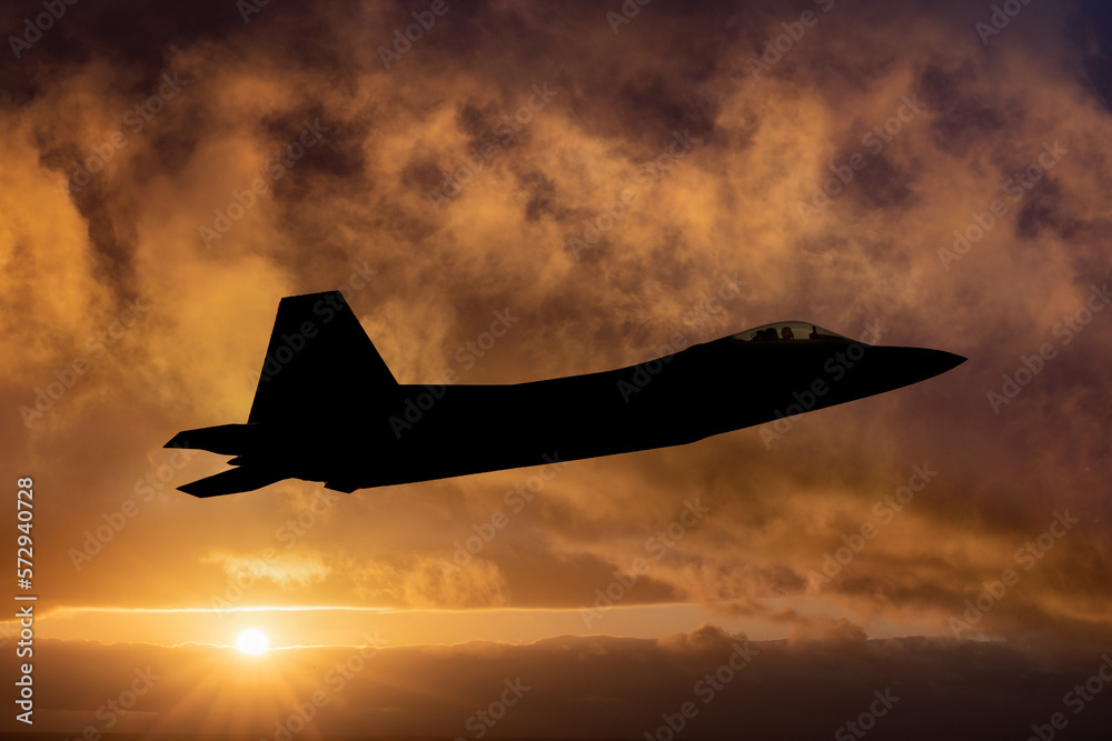 F-22 Raptor Fighter Jet on a combat mission. Sunset silhouette of