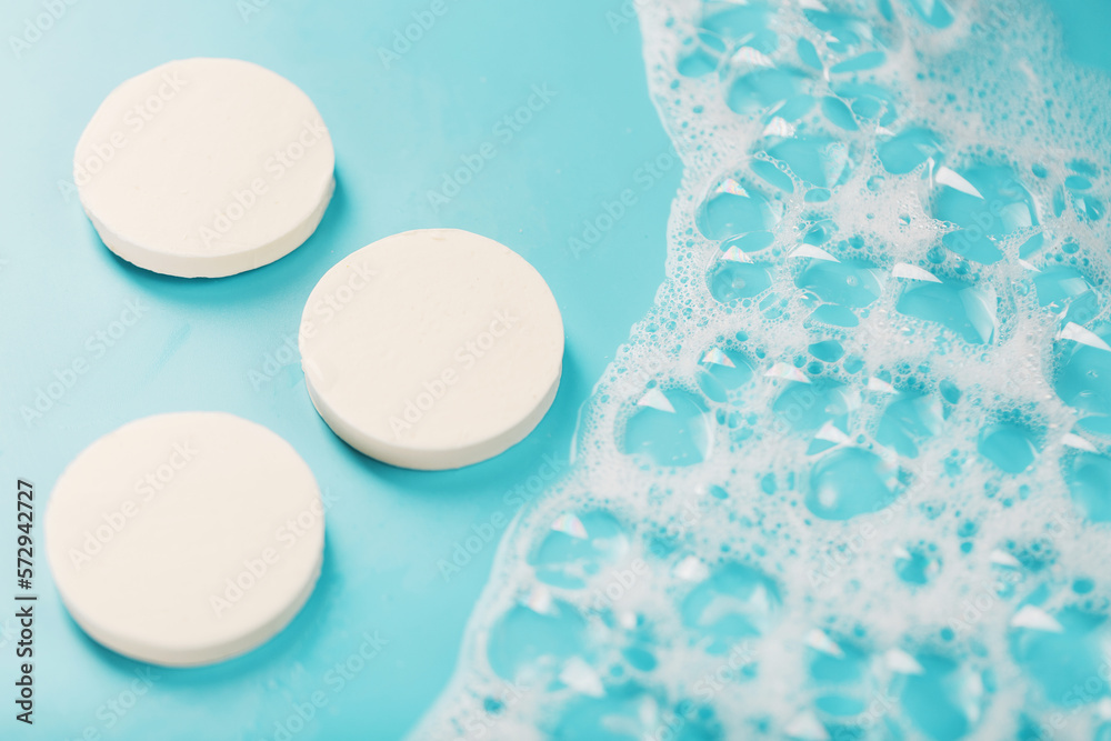 Three round pieces of white soap with foam Three round pieces of white soap with foam
