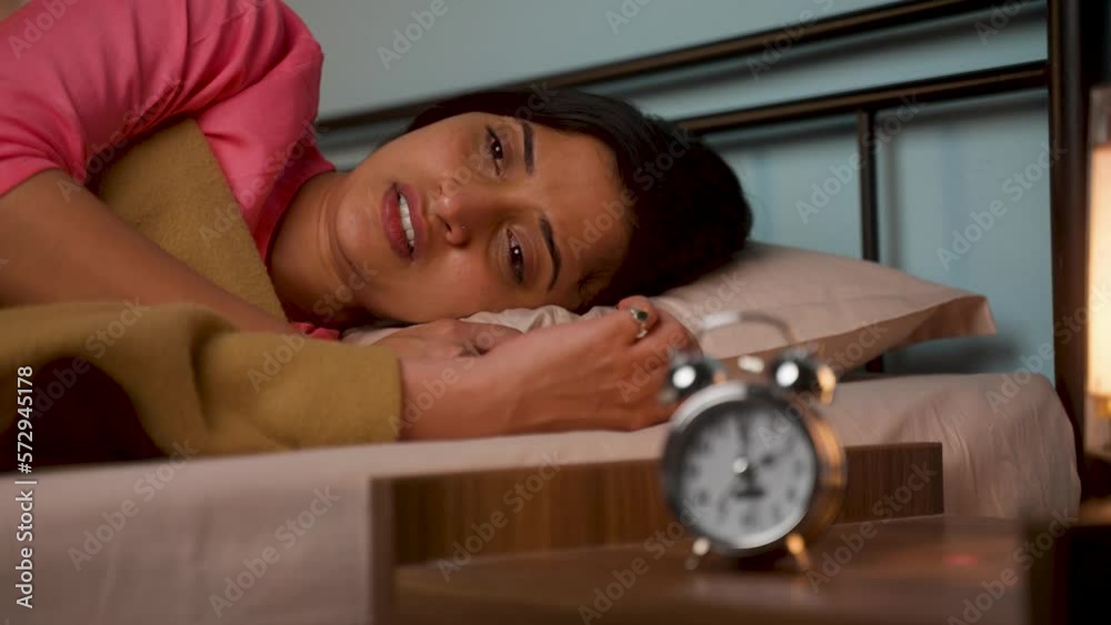 young girl unable to sleep at night due to insomnia - concept of health care, illness and nightmare or depression.