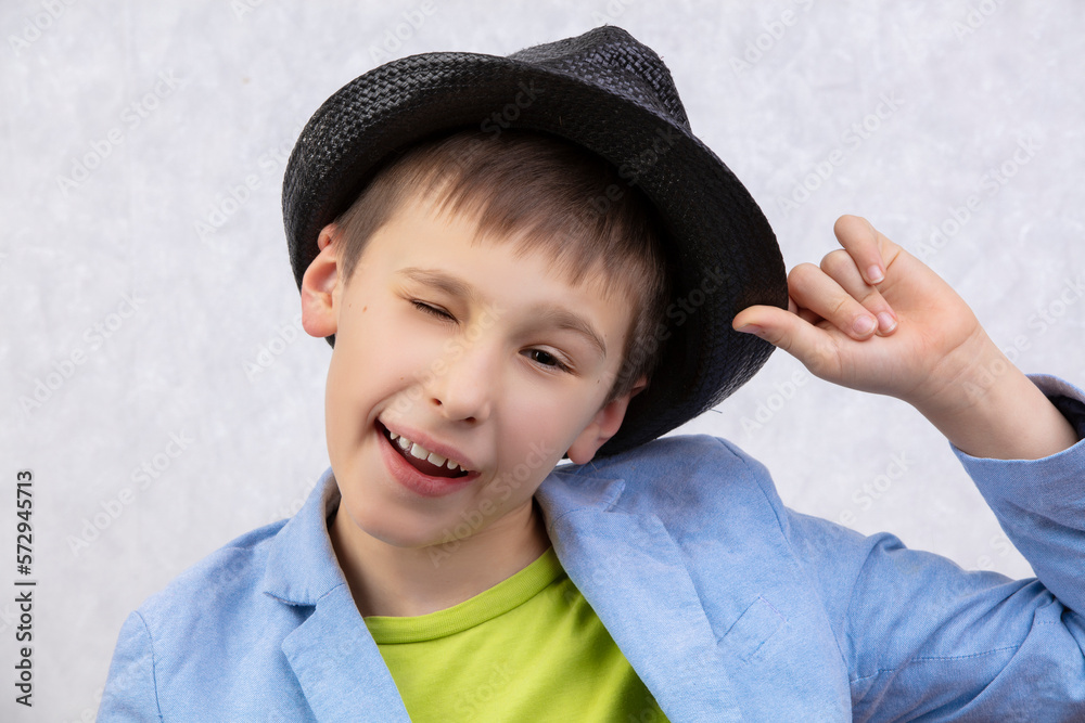 Portrait of a handsome cheerful winking boy in a hat. Portrait of a handsome cheerful winking boy in a hat.