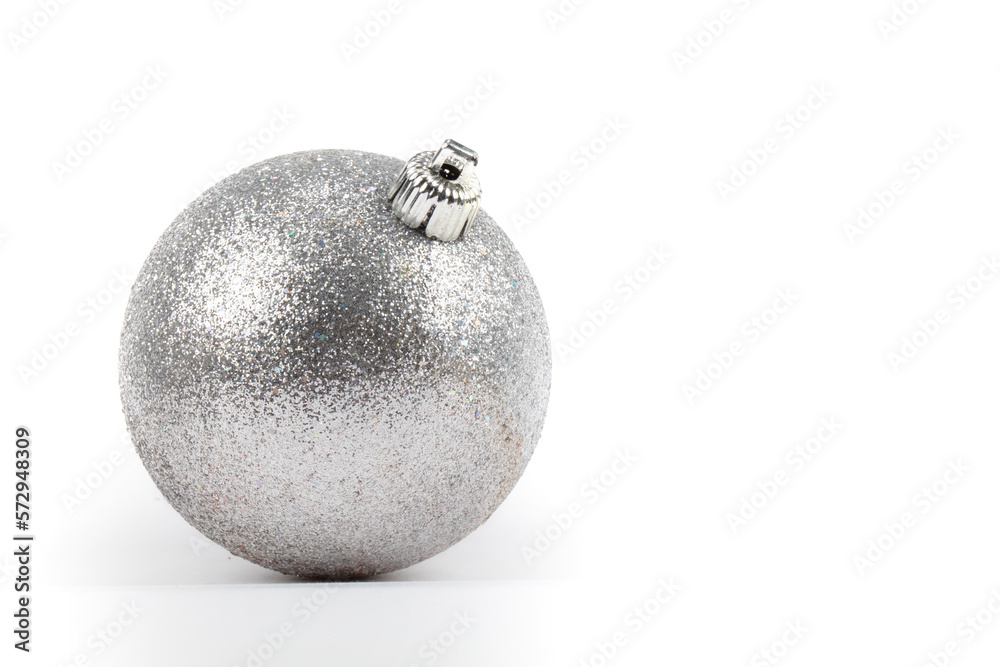 Festive background. On a gray background, a silver Christmas round ball. Festive background. On a gray background, a silver Christmas round ball.