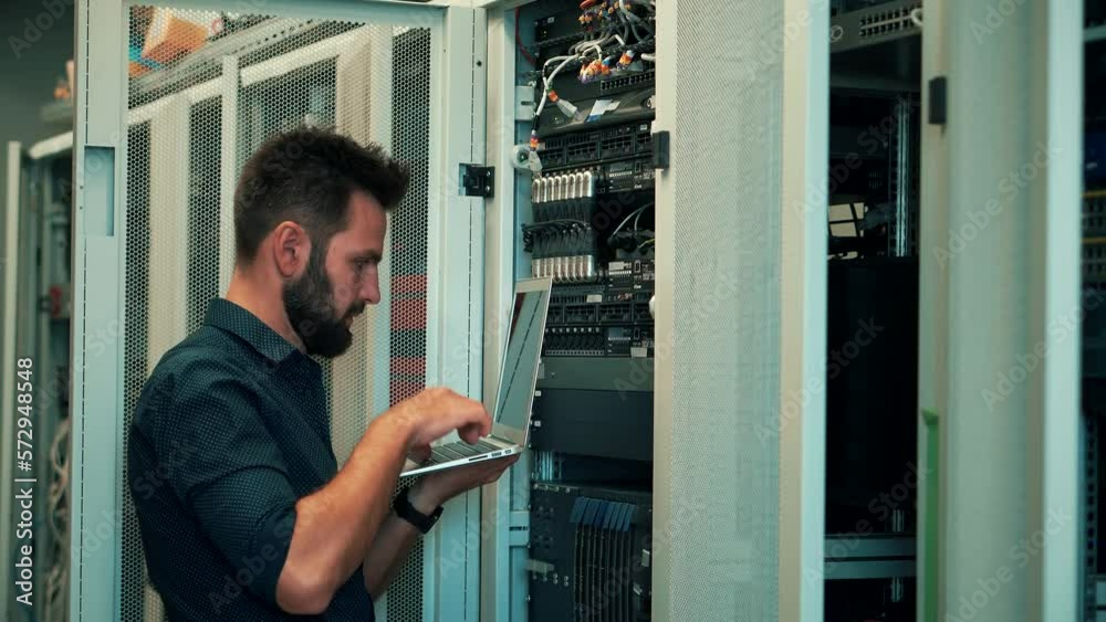 specialist configuring server rack in server room specialist configuring server rack in server room