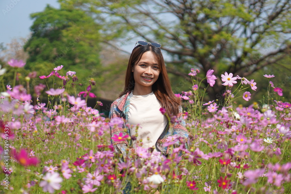 Happy Asian woman in cosmos flower garden Happy Asian woman in cosmos flower garden