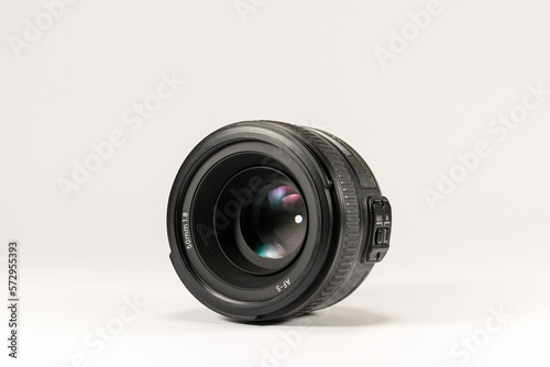 50mm 1.8 lens on a white background with a closed aperture.