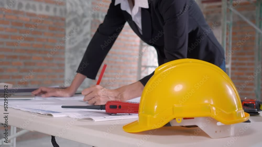 Closeup hands young caucasian architect woman looking laptop and working drawing blueprint for planning building house, engineer thinking and sketching blueprint for construction, industry concept. Closeup hands young caucasian architect woman looking laptop and working drawing blueprint for planning building house, engineer thinking and sketching blueprint for construction, industry concept.
