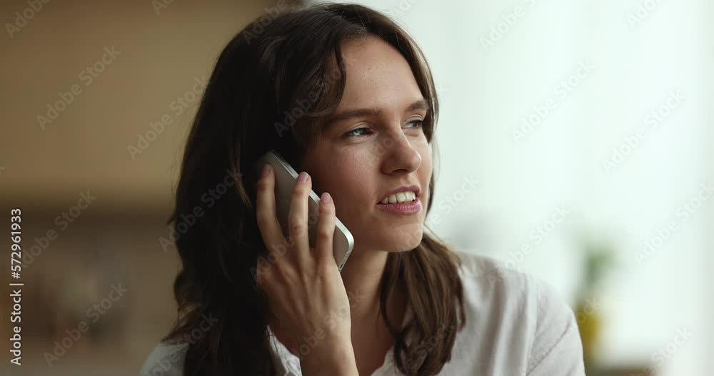 Cheerful engaged pretty young customer woman talking on mobile phone, chatting, speaking to friend, smiling, giggling, laughing, sharing good news. Telephone communication Cheerful engaged pretty young customer woman talking on mobile phone, chatting, speaking to friend, smiling, giggling, laughing, sharing good news. Telephone communication