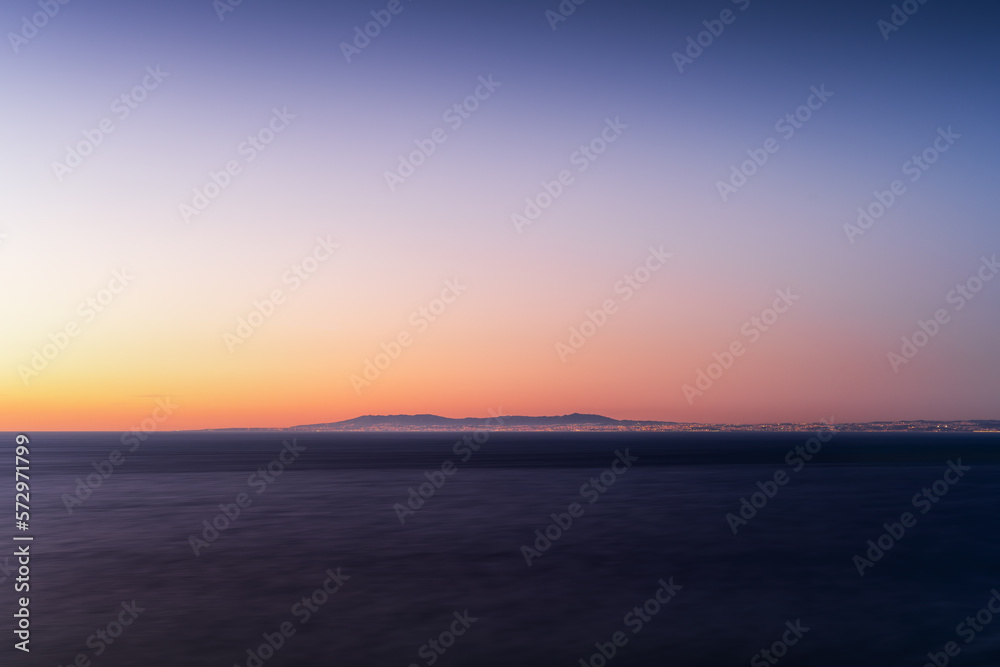 Colourful twilight over the ocean, long-exposure with Atlantic Ocean on foreground and Lisbon, Cascais and Sintra on background, Colour Photo, Cabo Espichel, Sesimbra, Portugal