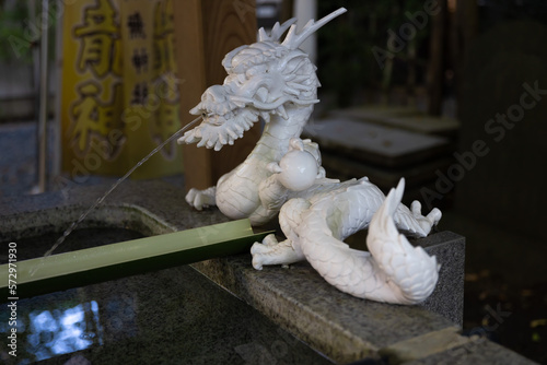 A statue of dragon at purification fountain in Japanese Shrine