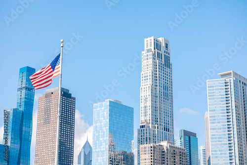 American flag flying against backdrop of downtown skyline