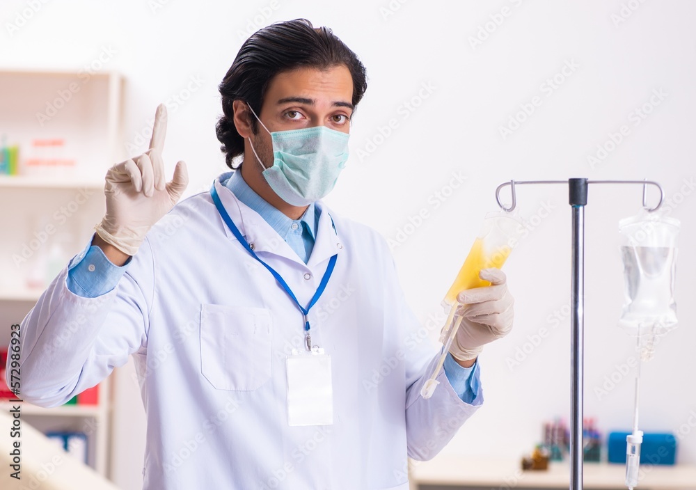 Young male doctor in blood transfusion concept Young male doctor in blood transfusion concept