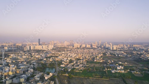 Wallpaper Mural aerial drone shot flying over small buildings houses and green feilds and lakes towards elevanted six lane highway in the distance going from gurgaon to Sohna Torontodigital.ca