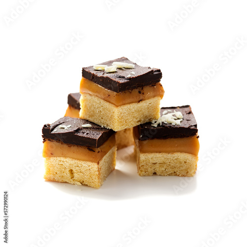 Millionaire's shortbread with chocolate and caramel isolated on white