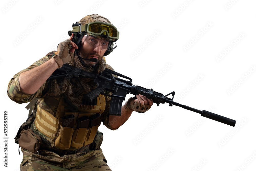 A professional mercenary soldier during a special operation calls for support on the radio while looking at the camera. A professional mercenary soldier during a special operation calls for support on the radio while looking at the camera.