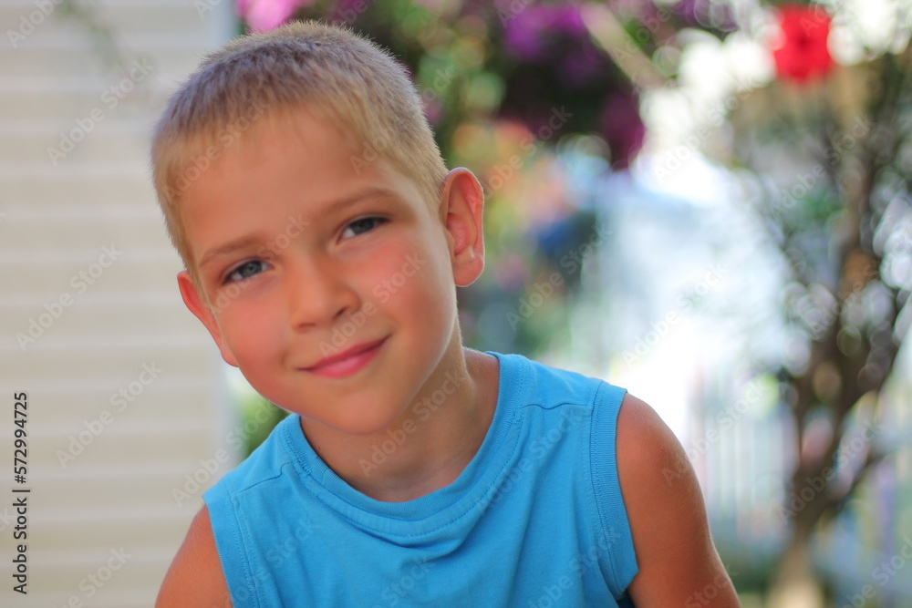 The portrait is a close-up of a young schoolboy, likely around eight years old, standing in a lush garden. The portrait is a close-up of a young schoolboy, likely around eight years old, standing in a lush garden.