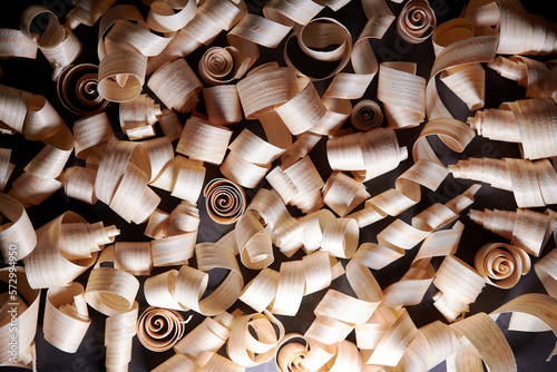 Wood shavings on dark background. Wooden shaving at old plank board texture. Above view