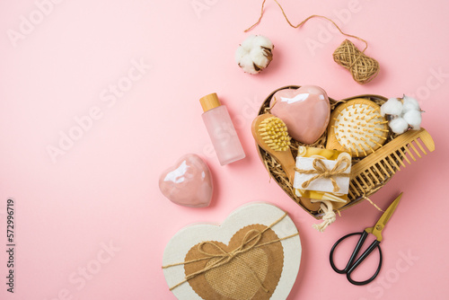 Mothers day heart shape gift box with natural eco friendly home spa products on pink background. Top view, flat lay