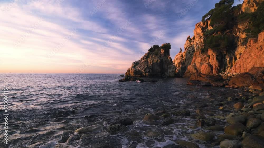 Colorful sunrise on the rocky coastline of the sea (Costa Brava, Cala s'Agulla, Blanes, Spain) Colorful sunrise on the rocky coastline of the sea (Costa Brava, Cala s'Agulla, Blanes, Spain)