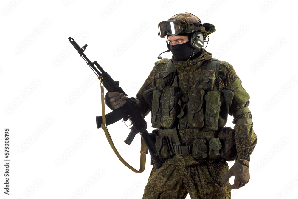 Cropped photo of a russian mercenary soldier with AK-74 in his hand and looking by side. Cropped photo of a russian mercenary soldier with AK-74 in his hand and looking by side.