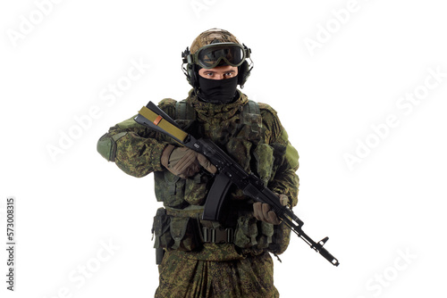Cropped photo of a russian mercenary soldier with AK-74 in his hand and looking at camera.