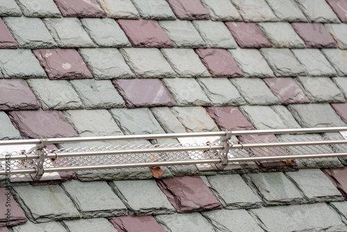 Slate roofing tiles with snow and ice guard on a historic building.  Attractive  durable roofing material. 