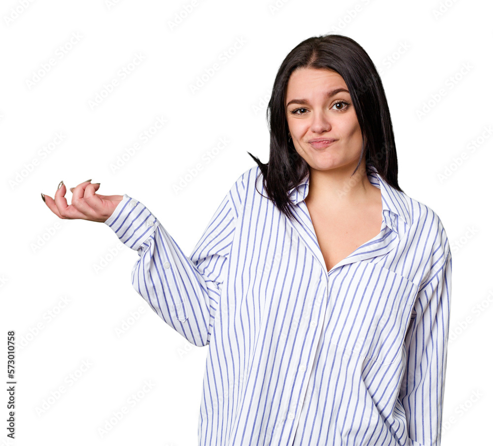 Young caucasian woman isolated doubting and shrugging shoulders in questioning gesture. Young caucasian woman isolated doubting and shrugging shoulders in questioning gesture.