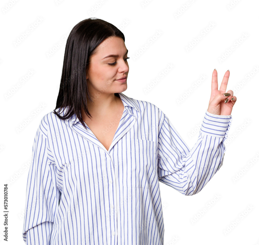 Young caucasian woman isolated joyful and carefree showing a peace symbol with fingers. Young caucasian woman isolated joyful and carefree showing a peace symbol with fingers.