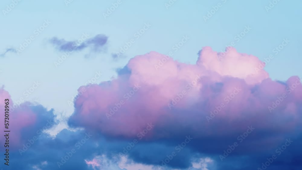 Fantastic cute pink and light blue cumulus clouds float changing shapes across clear sky with wind flow in morning timelapse
