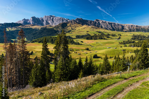 Panoramic view of Alpe di Siusi landscape. View of beautiful vibrant green Seiser Alm meadow from the top cable car station from Ortisei. South Tyrol, Dolomites, Alps, Italy.