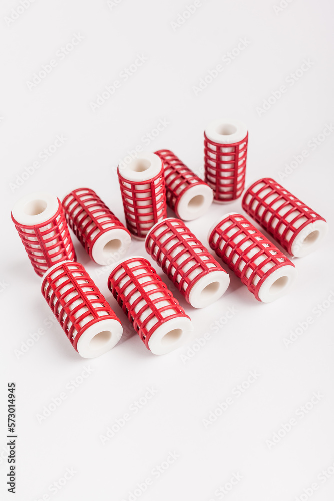 Fototapeta premium a set of several unfolded women's hair curlers on an isolated white background