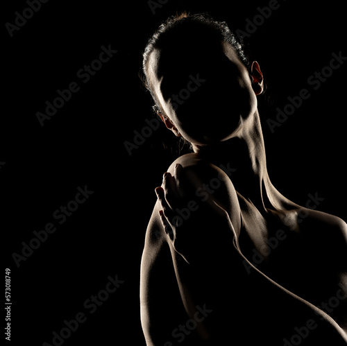 Canvas Print Sensual portrait silhouette of beautiful woman in backlight on a black backgroun