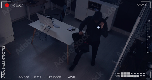 Thief Stealing Computer From Office photo