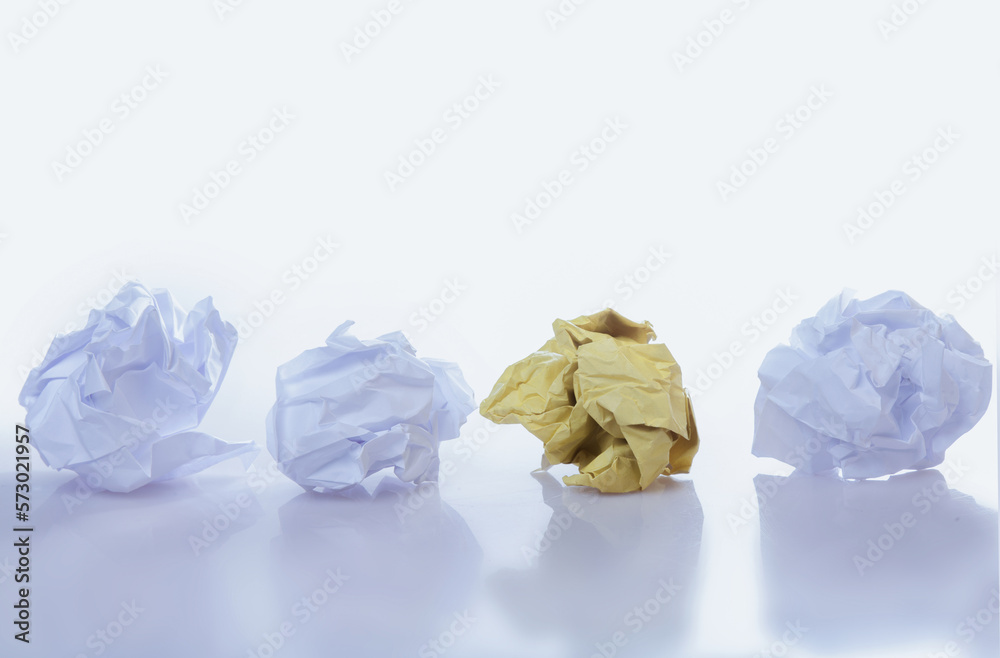 Be different concept. Yellow and white crumpled paper balls. Horizontal image. Be different concept. Yellow and white crumpled paper balls. Horizontal image.