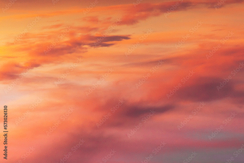 Gorgeous abstract view of pink and purple glowing cloudy sky after winter sunset. Magnificent colour shades of rolling clouds at the end of the day