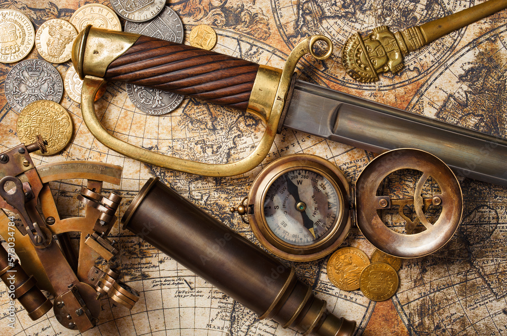 Vintage still life with compass, sextant, spyglass, saber. Pirates gold coins treasure.