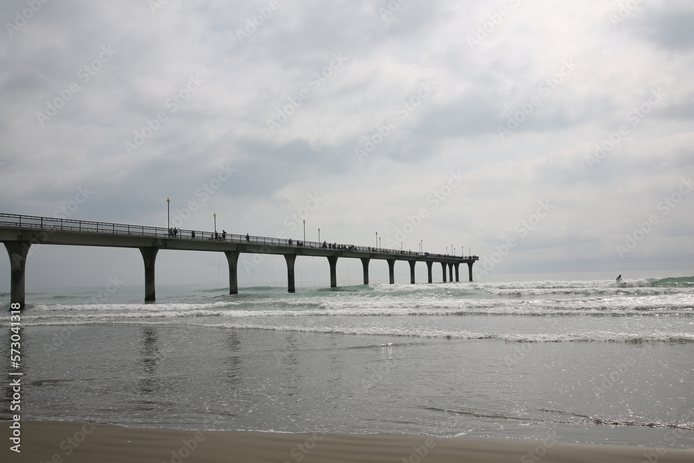 ocean pier with cloudy sky