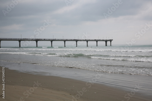 Ocean pier with cloudy sky