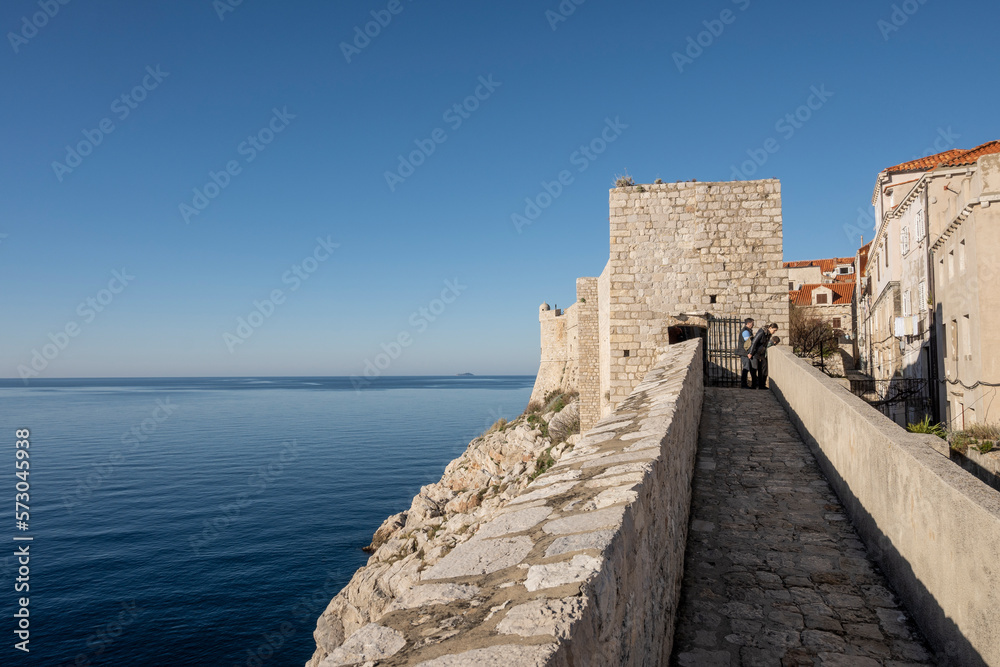 Old gun towers on the Dubrovnik city fortified walls looking on the horizon above Adriatic sea, Croatia