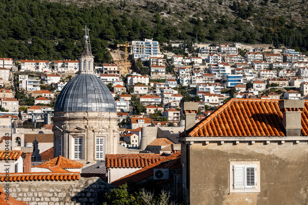Beautiful church tower of the Cathedral of the Assumption of the Virgin Mary, rising above red rooftops of Dubrovnik city, Croatia